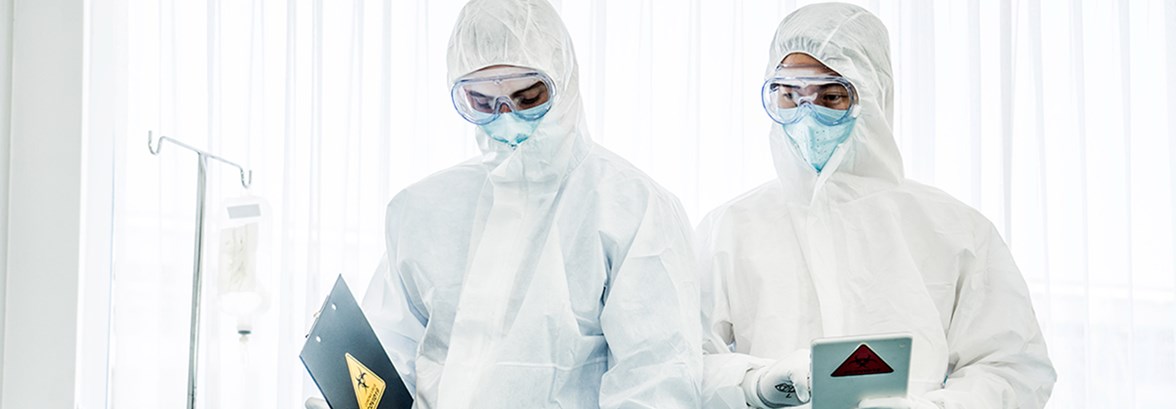 Doctors standing in protective white suite